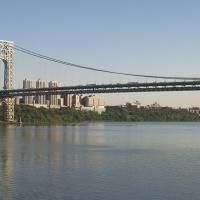 George Washington bridge over river, with buildings in background.